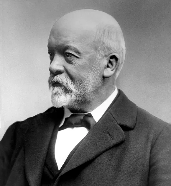     Gottlieb Daimler - black and white portrait of the German engineer in an elegant suit with bow tie, taken in the style of historical 19th century photographs.
